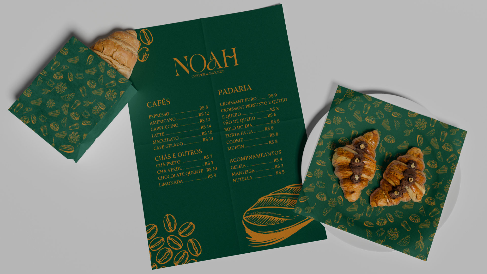 Card&aacute;pio da NOAH em verde com o padr&atilde;o impresso, aberto ao lado de croissants sobre a mesa.